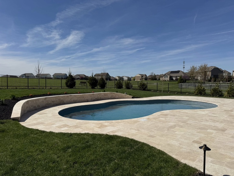 Side-by-side comparison of a vinyl liner pool and fiberglass pool in Ohio backyards