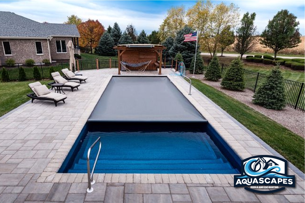 Multi-tier stone retaining wall with landscaping and excavation equipment in Ohio